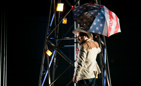 Man holding umbrella with US Flag design - photo by Eoin Carey
