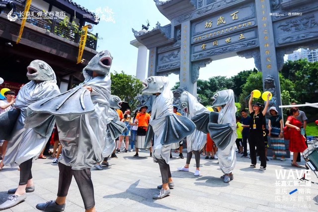 A group of people in fish costumes stand on the street in China