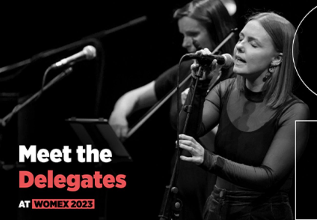 Meet the Delegates WOMEX 2023 text over a black and white image of a woman singing in front of a band