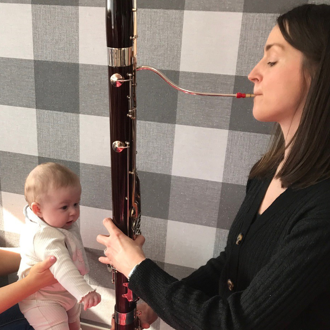 Musician Yvonne Wyroslawska playing the bassoon for a baby