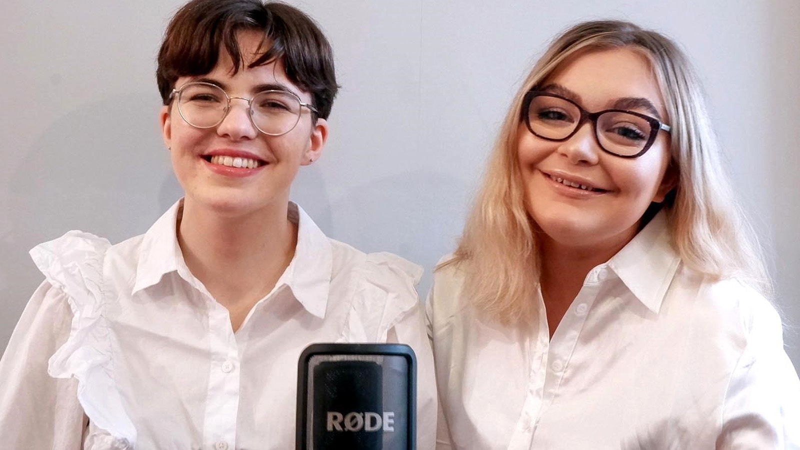 Brass musicians Iona and Laura smile for the camera in a promotional photo for the SBBA speaks podcast