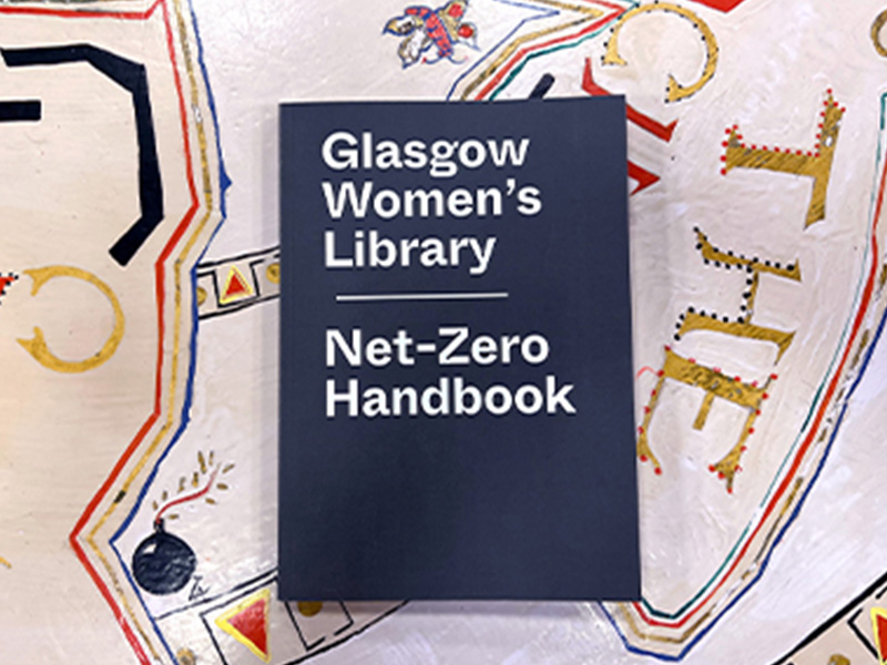 A booklet that says Glasgow Women's Library Net-Zero Handbook on the front cover