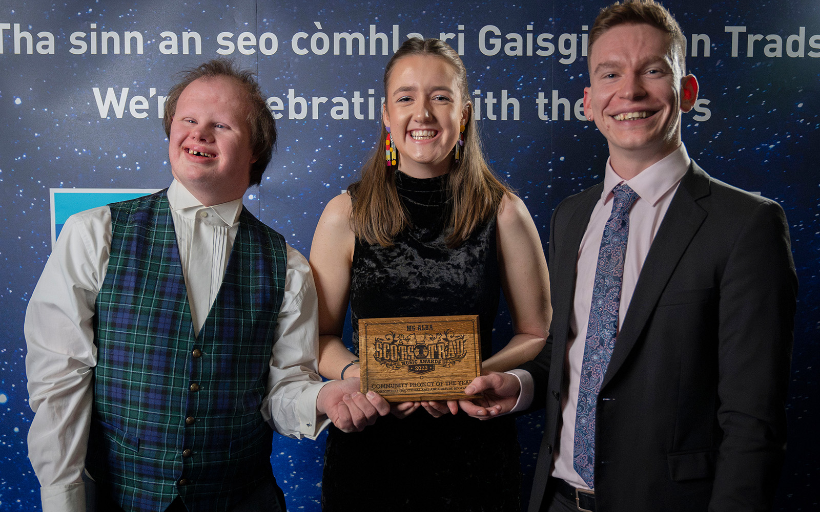 Magnus Turpie (L), Freya Taylor (middle) and Christian Gamauf (R) of Fèis Rois Ceilidh Trail accept the award for Community Project of the Year
