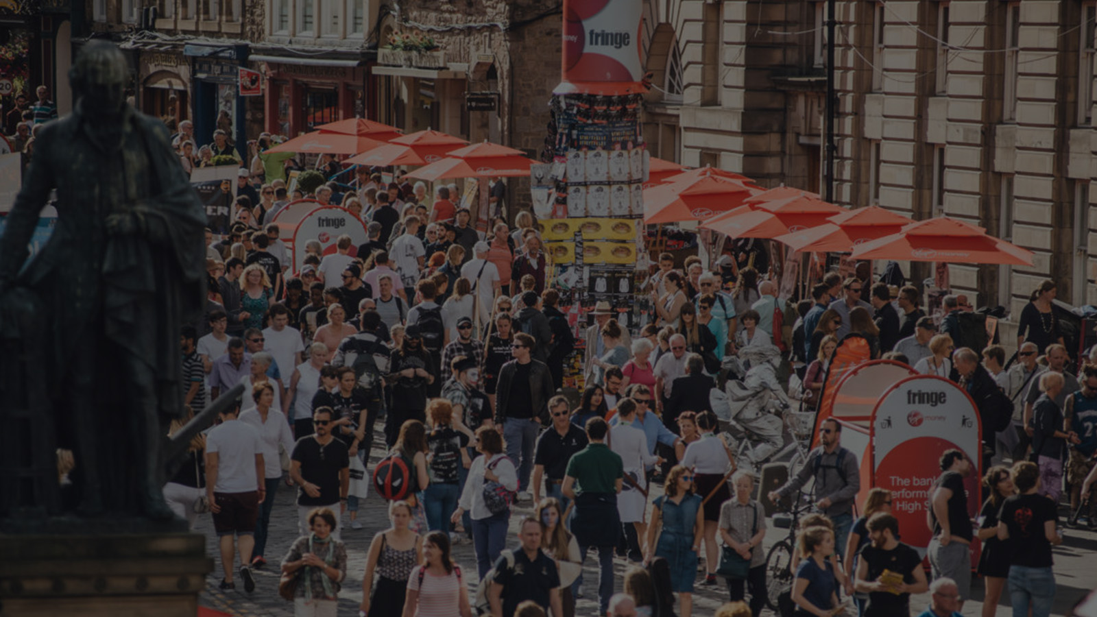 A street scene during the festivals in August in Edinburgh with crowds of people enjoying themselves