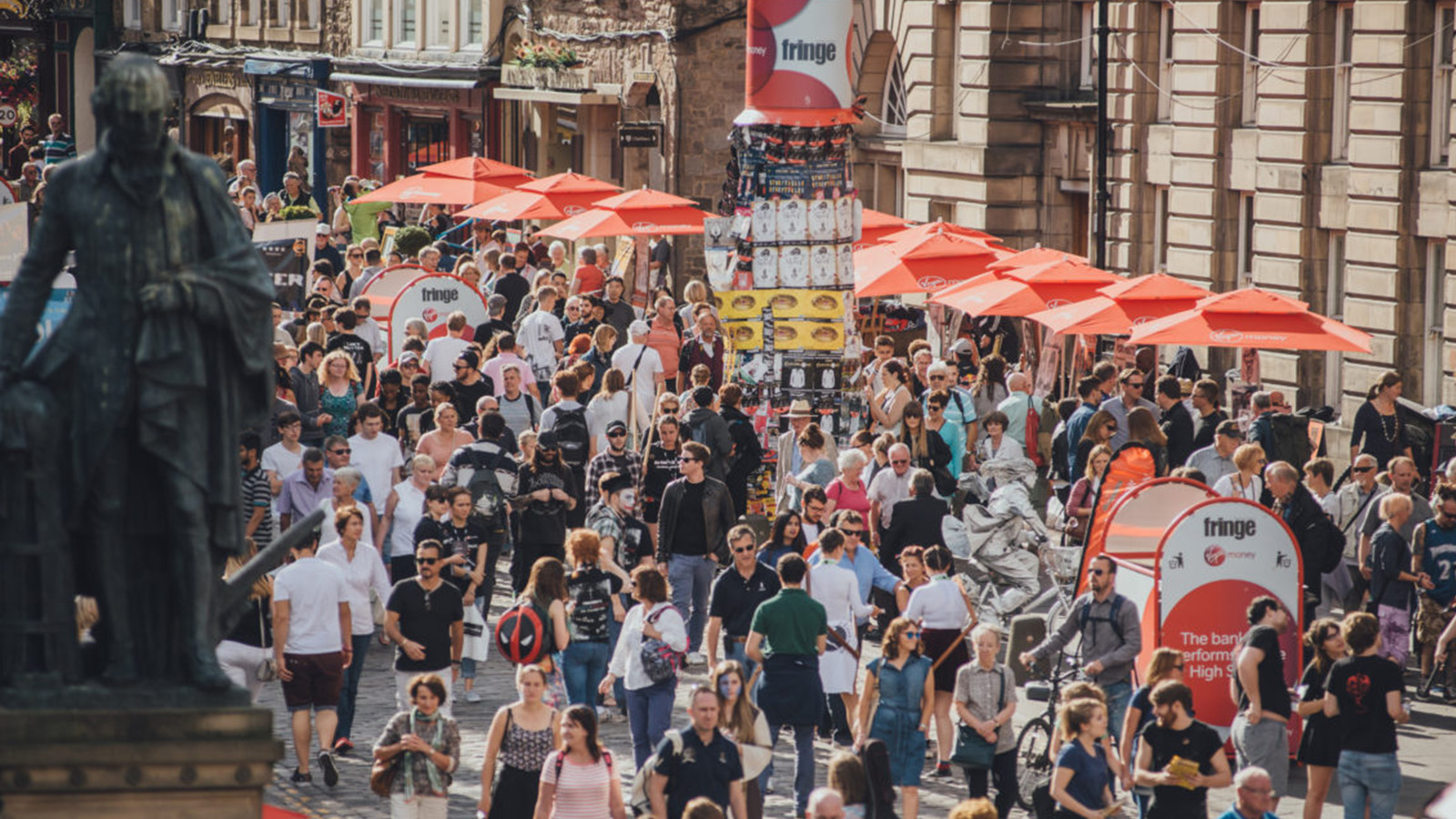 A street scene during the festivals in August in Edinburgh with crowds of people enjoying themselves