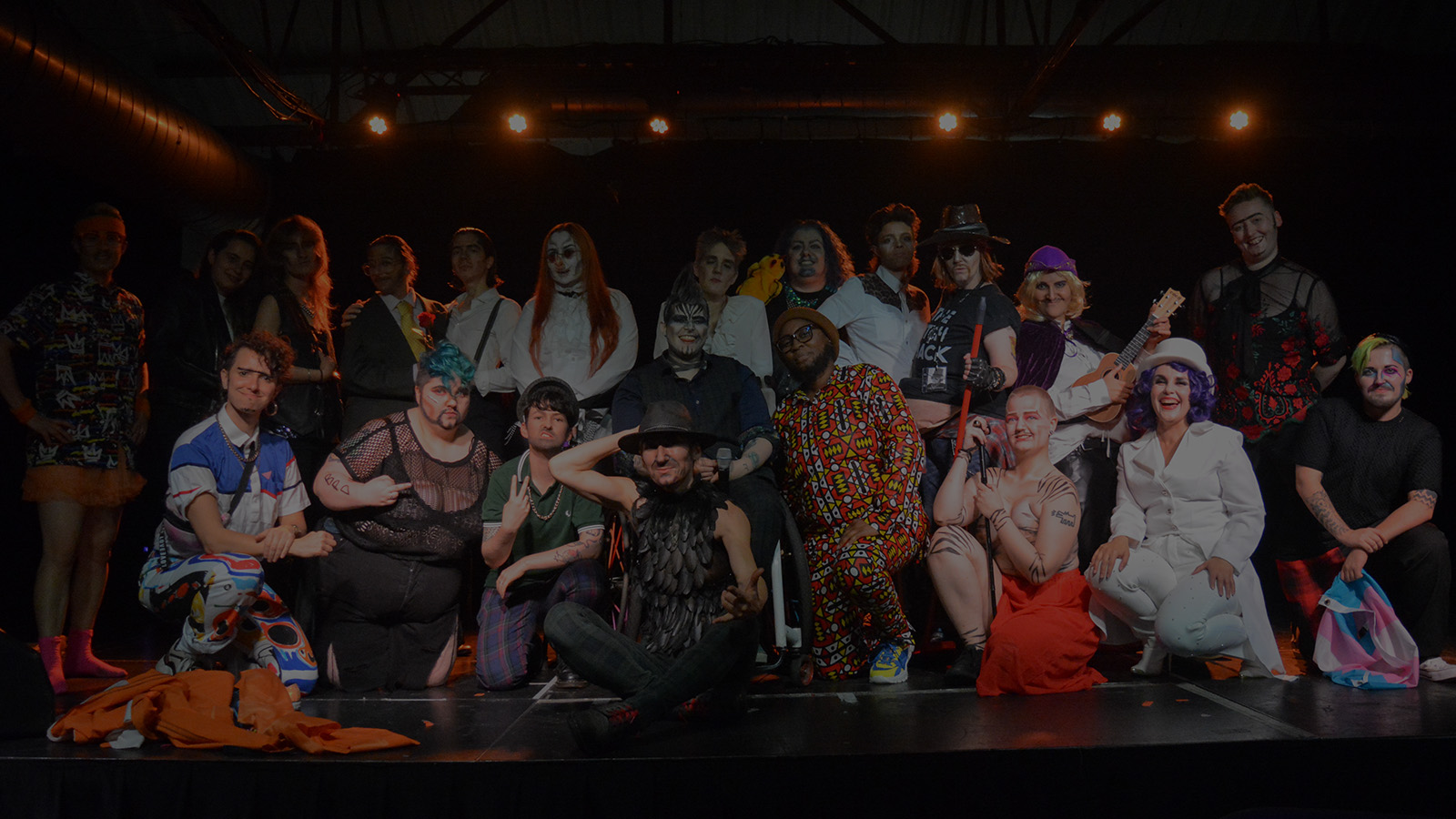 Drag Kings gathered together onstage at a Shut Up and King event