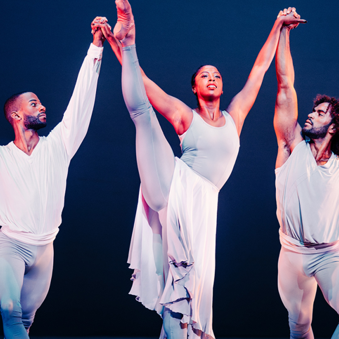 Alvin Ailey American Dance Theater at Edinburgh International Festival © Andrew Perry - ballet dancers on stage with two male dancers supporting a female dancer in the centre, who has her leg extended up past her head in the air