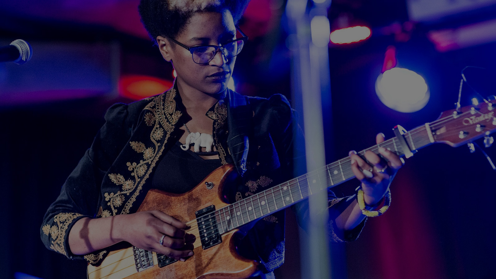 Musician Beldina Odenyo. A woman playing the electric guitar.