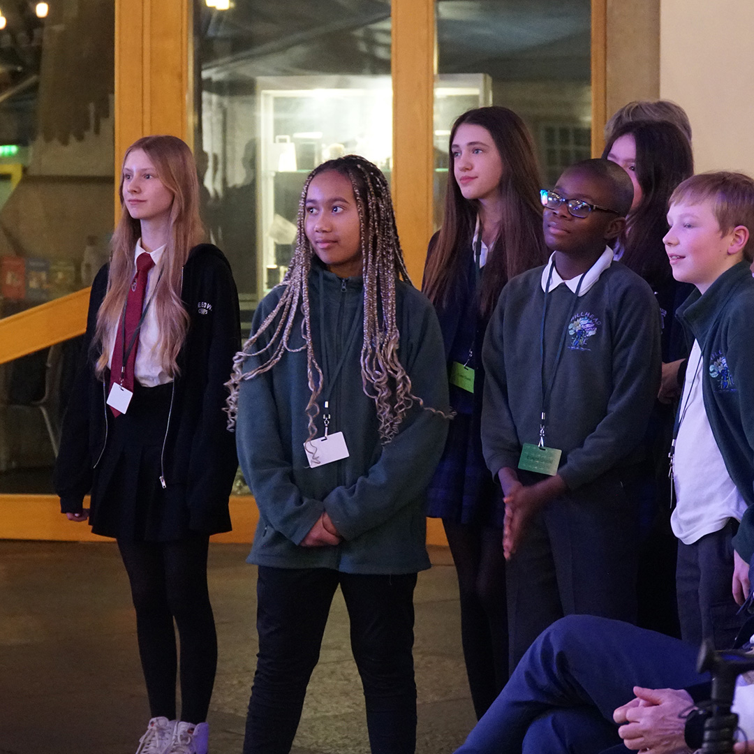 A group of children stand in the Scottish Parliament