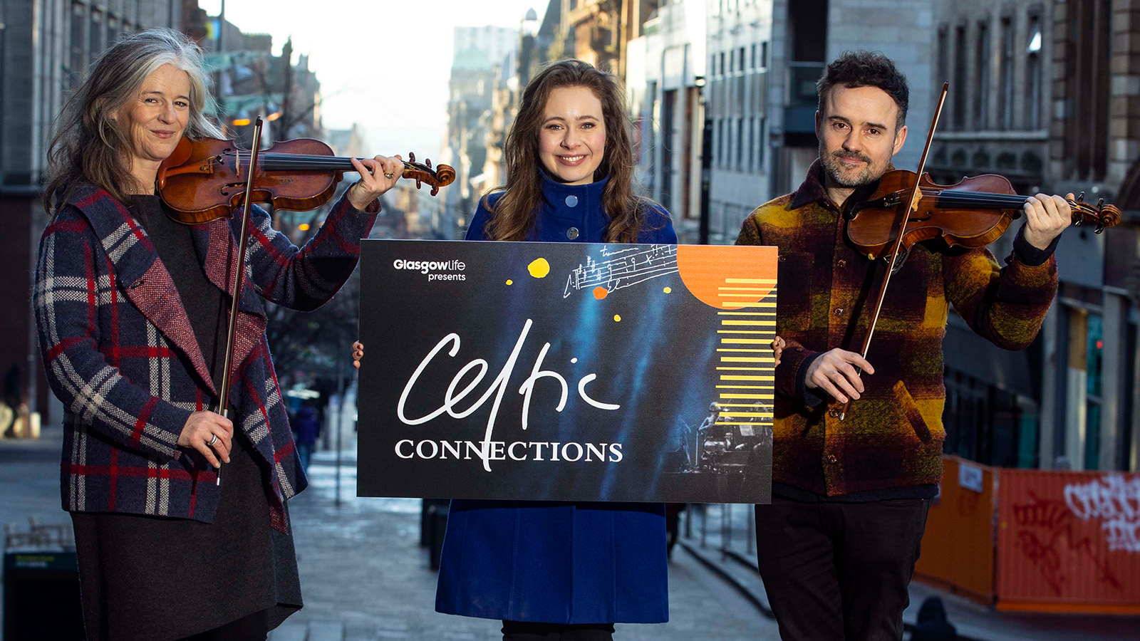 Violinist Joanne Green, Gaelic singer Mischa Macpherson and fiddle player Donald Grant gather on the steps of Glasgow Royal Concert Hall on Thursday 18 January for the opening of Celtic Connections 2024.