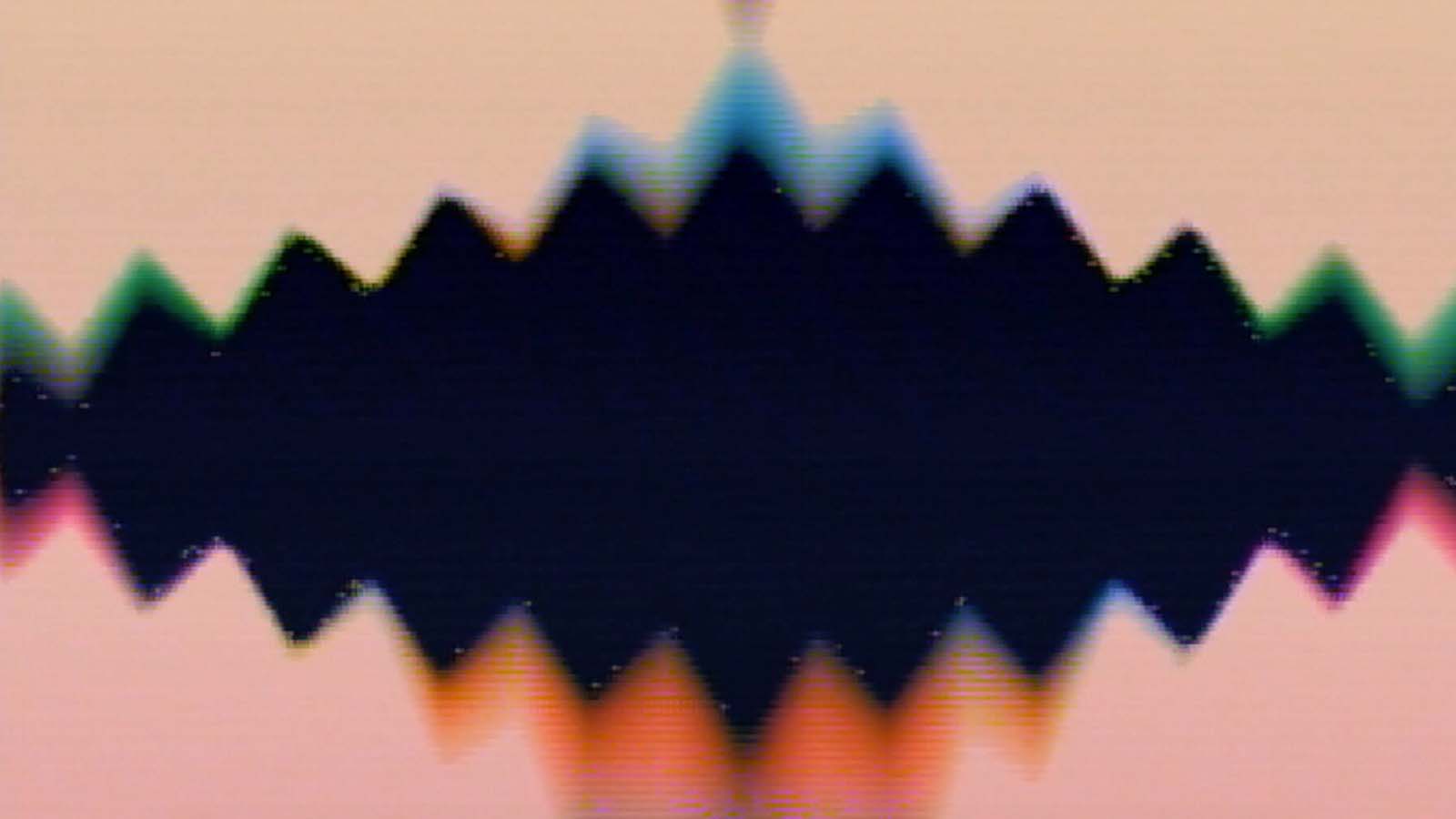 An abstract image pf a black spiky shape surrounded by soft pink, blue and orange light